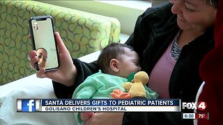 Santa delivers Christmas gifts to pediatric patients.