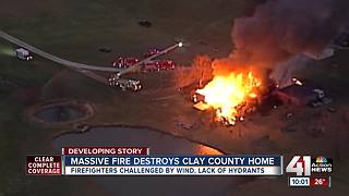 Crews battle large house fire in rural Clay Co.