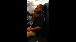 Sleepy Guy Forgets He Is On An Airplane And Lights A Cigarette