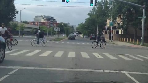 Cyclists blow red light, cause near-miss collision