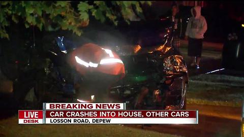 Driver crashes into parked cars, sends car into house in Depew