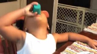 Child tries to drink shot of apple juice