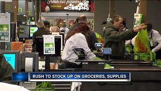 Long lines and bare shelves as people stock up at area grocery stores