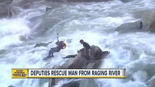 VIDEO: Deputies use a helicopter to rescue man stuck on a rock in raging river