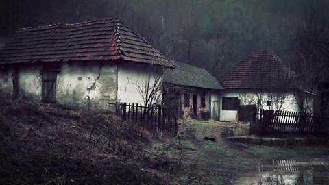 Rain over a remote white cottage farmhouse in the Romanian countryside