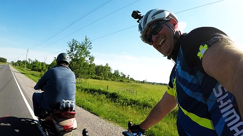 Cyclist and scooter driver duel it out on the highway