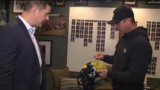 Jim Harbaugh shows off custom helmet during office tour