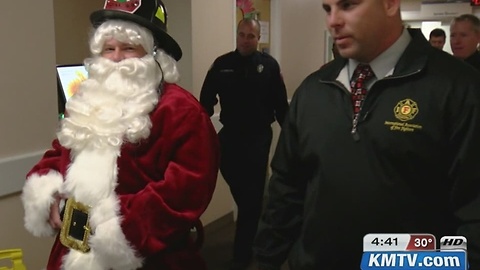 Firefighter dresses as Santa, delivers toys to sick kids