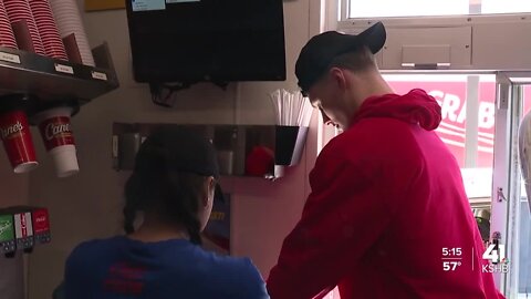 3 KU basketball players pass out chicken fingers at Lawrence Raising Cane’s Wednesday