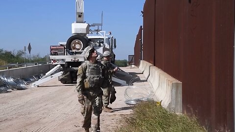 Soldiers Top Border Wall With Concertina Wire