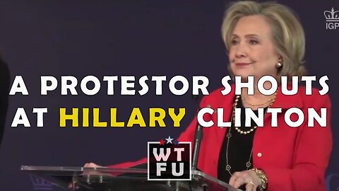 A Protester shouts that Hillary Clinton is a