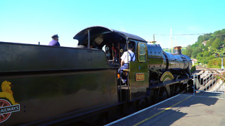 Steam train departs station