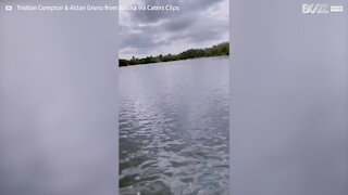 Young man falls into lake and catches fish with bare hands