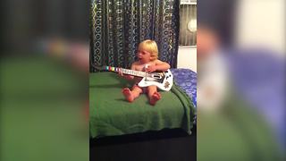 Baby Boy Loves Playing The Guitar