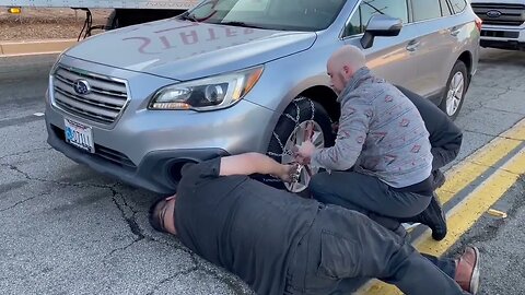 Crestline resident Danny Pritchett got help from complete strangers installing chains this morning