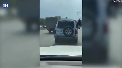 Russian woman's falling from moving SUV doing a BELLY DANCE