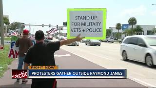 Protesters gather outside Raymond James