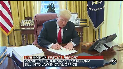 President Trump signs tax reform bill into law in oval office