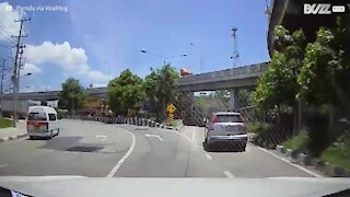 Motorcyclist collides with car but rides away unfazed