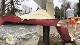 Wind storm powerful wraps canoe around a street sign