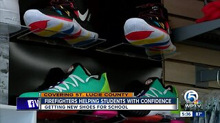 Firefighters helping students with new shoes for school