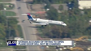 Woman accused of trying to open plane door will not be charged