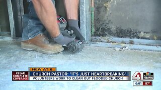 Volunteers work to clean out flooded church