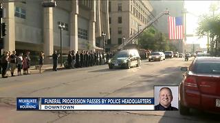 Officers salute fallen MPD officer's hearse as it passes police administration building