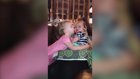 "A Tot Girl Tries to Kiss Her Baby Brother, But He Spits Up on Her"