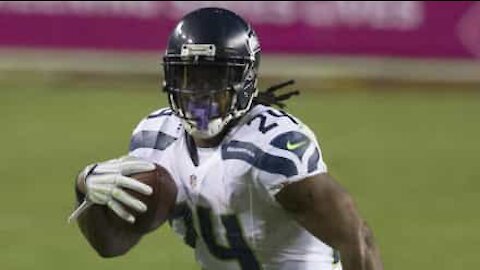 NFL player Marshawn Lynch hands out masks!