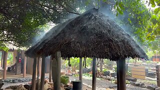 A heavy storm in northern Oahu Island Hawaii; Steam out of a roof at Polynesian Cultural Center.