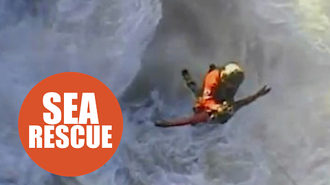 Incredible scenes as two young men rescued by Coastguard winchman are battered by massive waves