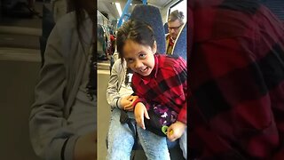 Baby girls, sisters laugh and joke in the train