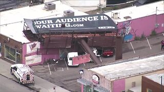 Strong winds topple billboard on South Broadway
