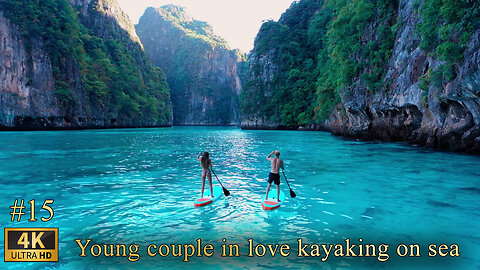 Young couple in love kayaking on sea together on a tropical climate.