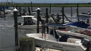 Storm surge sweeps away marina and dozens of boats