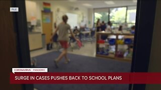 Surge in cases pushes back to school plans