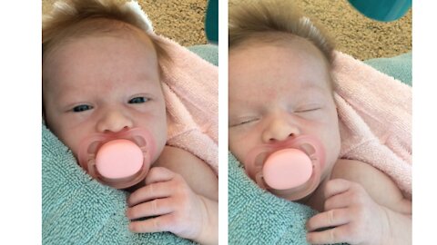 Adorable baby girl loves having her hair dried