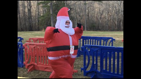 Santa running through a river, and a guy tripping