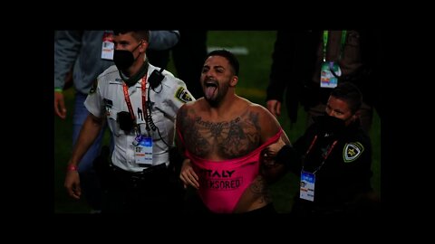 Man in swimsuit runs on field before being tackled by security during Super Bowl