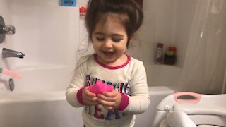 One Year Old Squirts Herself in the Face with her Bath Tou