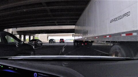 Car comes within inches of collision with merging 18 wheel truck