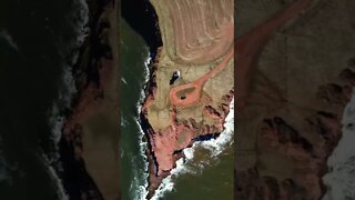 Flying drone right above cliffs