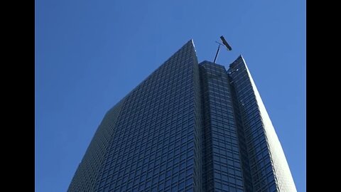 Men Tossed Around In High Winds on Skyscraper