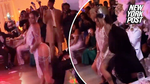 Bride wearing a thong and backless dress gives groom a wedding reception lap dance in front of guests, Twitter explodes