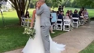 Newlywed couple falls after attempting a romantic kiss