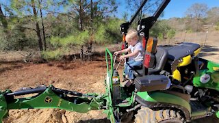 Youngest using a backhoe