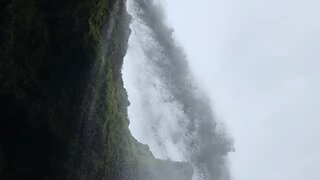Standing behind Iceland waterfall Svartifos.
