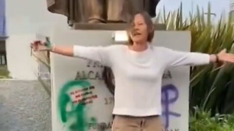 Heroic Woman Protects The Statue Of Saint Micheal From Leftist Activists Trying To Destroy It