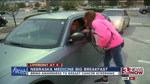 Breast cancer survivor helps hand out screening info at free morning meal